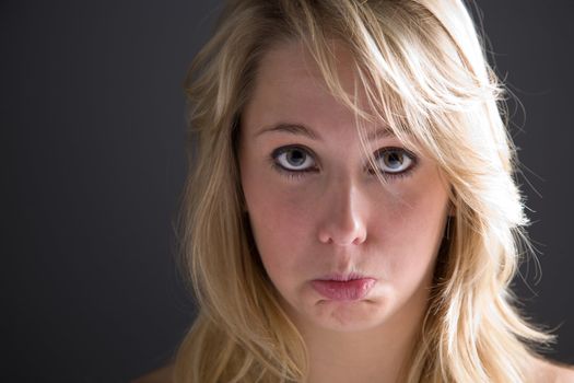 Cute young girl pulling a sad face 