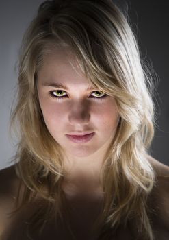 Young beautiful blond girl looking scary