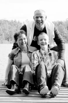 Happy family portrait on a sunny day in the forest