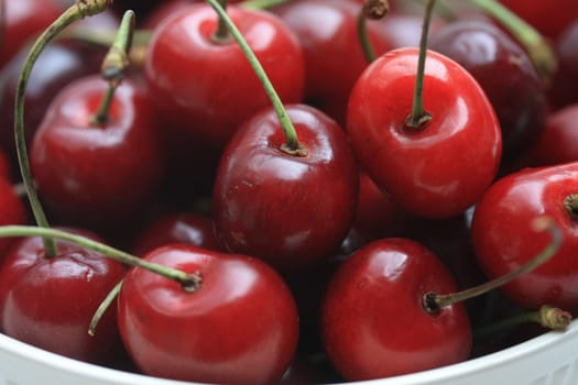 A group of juicy, fresh cherries in a bowl