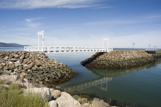 a small white bridge built on rocks