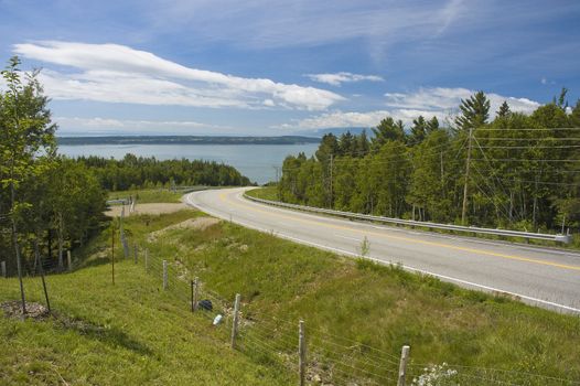 landscape with a curvy road, mountains and a sea