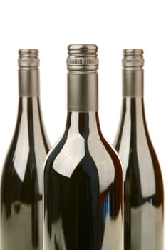Bottles of red wine isolated against a white background