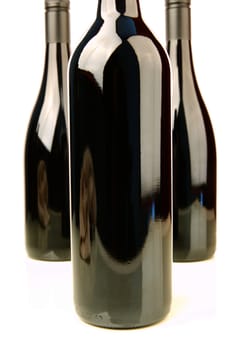 Bottles of red wine isolated against a white background