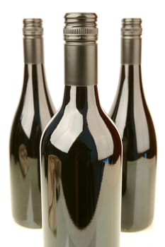 Bottles of red wine isolated against a white background