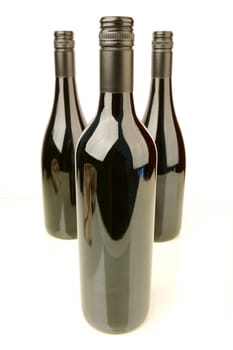 Bottles of red wine isolated against a white background