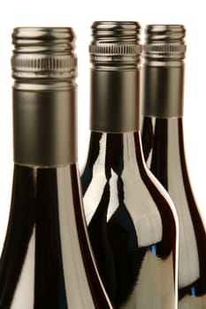 Bottles of red wine isolated against a white background