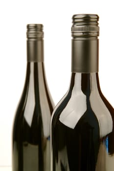 Bottles of red wine isolated against a white background