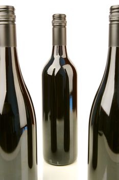 Bottles of red wine isolated against a white background