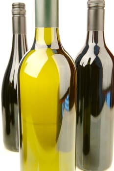 Bottles of red and white wine isolated against a white background