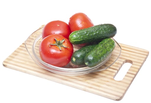 tomatoes and cucumbers on the cutting board 