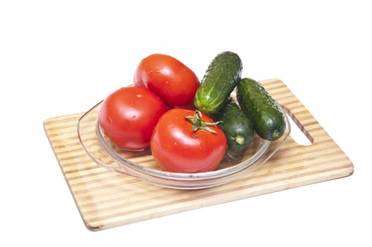 Tomatoes and cucumbers on the cutting board 