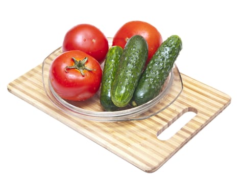 Tomatoes and cucumbers on the cutting board 