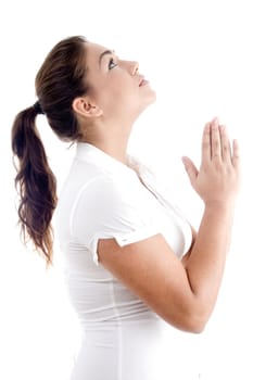 beautiful young female praying against white background