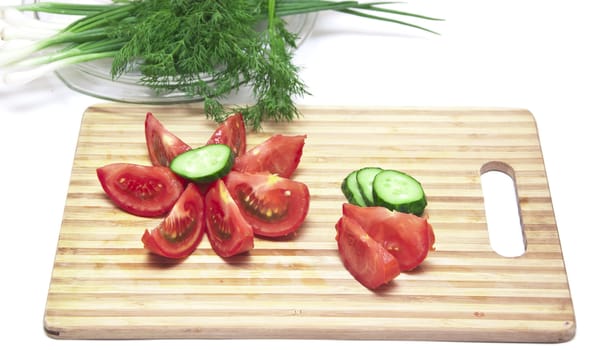 tomatoes and cucumbers on the cutting board