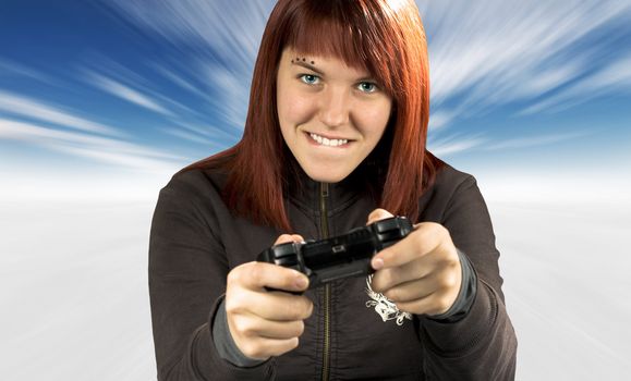 Photo of a happy beautiful redhead girl biting lips while playing video games.