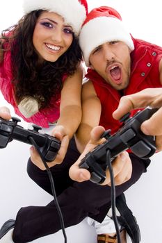 young loving couple on floor playing video game against white background