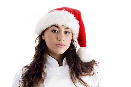 young chef wearing christmas hat and looking at camera on an isolated white background