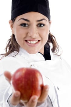 professional female chef showing fresh apple on an isolated white background