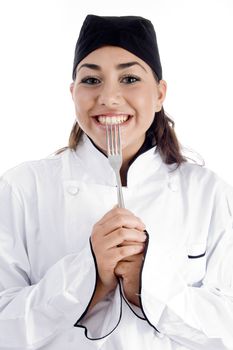 smiling female chef showing fork on an isolated background