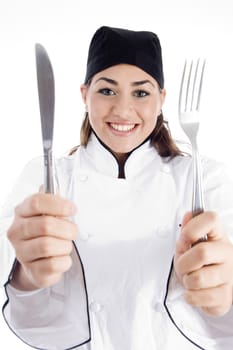 young chef holding metal cutlery with white background