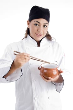 beautiful female chef posing with chopstick and bowl on an isolated white background