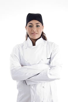 portrait of young beautiful chef posing with crossed arms against white background