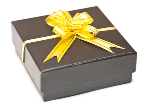 black gift box with golden ribbon isolated over white background 