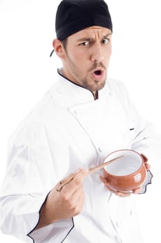 young chef holding bowl and chopstick and looking at camera on an isolated white background