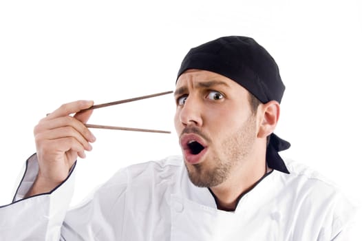 professional chef surprised with chopstick on an isolated white background