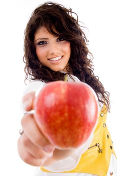 beautiful young woman holding red apple against white background