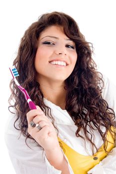 young pretty female holding toothbrush on an isolated white background