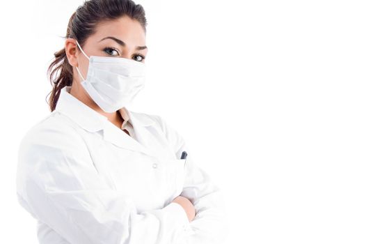 portrait of doctor with mask and folded hands on an isolated white background