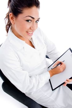 side pose of young doctor with writing pad on an isolated white background