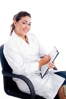 young smiling doctor sitting on chair on an isolated white background