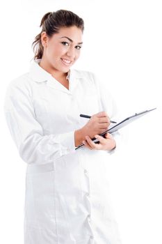 young female doctor writing on notepad on an isolated white background