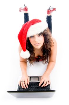 laying female with christmas hat and laptop on an isolated background