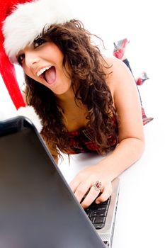 woman wearing christmas hat and working on laptop on an isolated white background