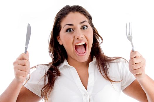 portrait of shouting woman with fork and knife against white background