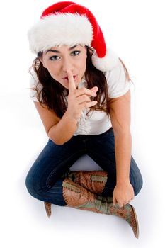 woman with christmas hat and asking to keep silent on an isolated background