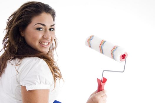 young female holding paint roller with white background