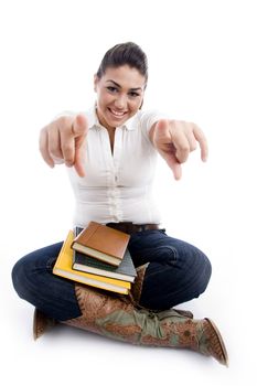 pointing smiling female with books on an isolated white background