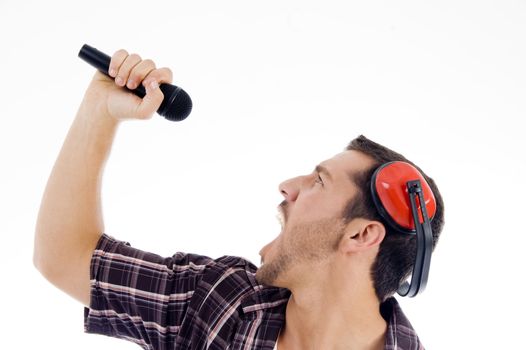male singing loudly on microphone on an isolated white background