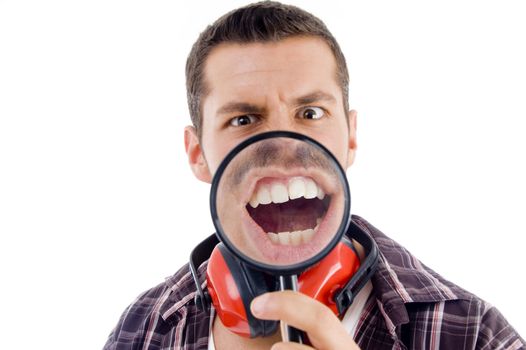 male showing teeth through magnifying glass on an isolated background