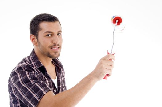 male holding roller brush against white background