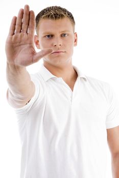 handsome male in stopping gesture on an isolated background