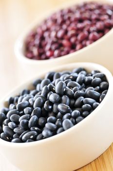 Dry black and red adzuki beans in bowls