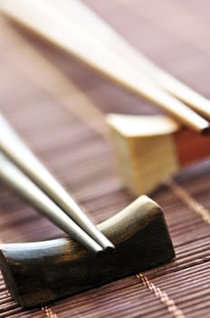 Two sets of wooden chopsticks on rests close up