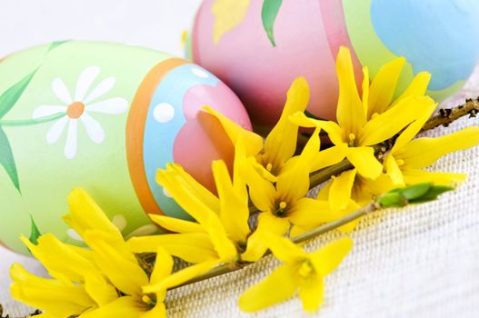 Easter eggs arrangement with yellow forsythia flowers