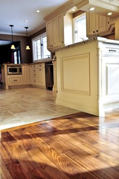 Hardwood and tile floor in residential home kitchen and dining room